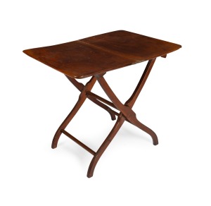 A rare Australian cedar coaching table with cross stretcher folding base, Tasmanian origin, mid 19th century, bearing remnants of a paper label "Lieu. Colonel Reid, Hobart", 70cm high, 86cm wide, 60cm wide when open.