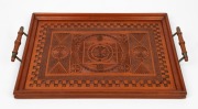 An antique Australian chip carved kauri pine serving tray, early 20th century, ​​​​​​​54cm across the handles.