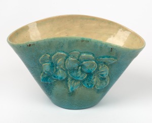 ARTIST UNKNOWN turquoise glazed pottery vase with applied floral decoration, incised signature to base partially obscured by glaze, 12cm high, 20cm wide