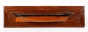 A vintage Australian pine half hull boat model with hand-painted highlights, early 20th century, 17 x 64cm.