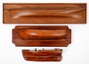 Three vintage half hull boat models, two on cedar back boards, 20th century the largest 16 x 67cm overall.