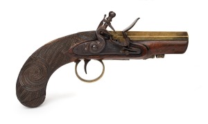 An antique English flintlock pocket pistol with early New Zealand Maori carved stock, late 18th century, 23cm long.