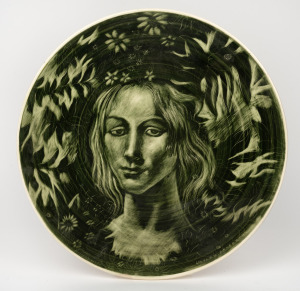 TOM SANDERS green glazed pottery plaque with hand-painted female portrait by "WESLEY PENBERTHY", 33.5cm diameter.
