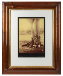 J. W. LINDT large format sepia tone photograph of two swagmen sitting beneath a tree, mounted on original card, stamped "J. W. Lindt, Melbourne", attractively displayed in an Australian cedar frame, sheet size 34 x 25cm, 71 x 58cm overall.