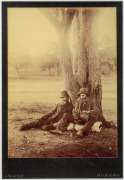 J. W. LINDT large format sepia tone photograph of two swagmen sitting beneath a tree, mounted on original card, stamped "J. W. Lindt, Melbourne", attractively displayed in an Australian cedar frame, sheet size 34 x 25cm, 71 x 58cm overall. - 2