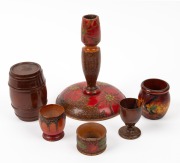 Australian pokerwork candlestick, egg cup (signed R. & A. Jones, Bendigo), napkin ring, fairy wren vase and mulga wood barrel with egg cup, circa 1920s, (6 items), the candlestick 18cm high