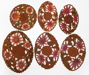 Six assorted hand-painted and cut leather doilies, circa 1920/30s, the largest 46cm wide