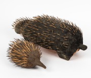 Two echidna sculptures, carved wood, paint and quills, the larger 48cm long - 2