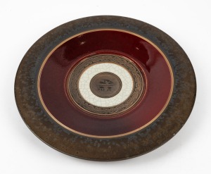 DAVID OSWALD pottery platter in burgundy and bronzed glaze with incised motif decoration, impressed mark to base, 38.5cm diameter