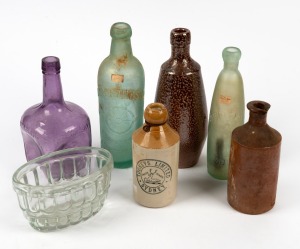 An antique glass jelly mould with kookaburra decoration; together with six assorted glass and pottery bottles, (7 items), the jelly mould 9.5cm high, 16cm wide