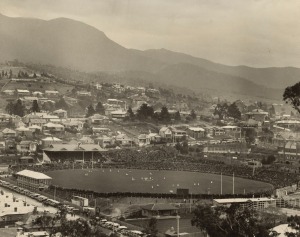 [TASMANIAN INTEREST] Group of twelve vintage mounted black and white photographs, including a large format aerial view of North Hobart Football Oval on Grand Final Day by Beattie Studios, the largest sheet size 30 x 38cm, 48 x 61cm overall