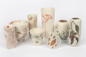Eight assorted Australian ceramic vases with botanical decoration including several examples by MOLLIE BOSWORTH, the largest 24.5cm high