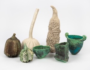 Seven assorted ceramic vases and seed pod ornaments, including several examples by MERRAN ESSON, the largest 39cm long