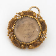 An antique 18ct gold pendant housing a somewhat faded photo portrait, early to mid 19th century, ​​​​​​​2.5cm high, 3.7 grams.