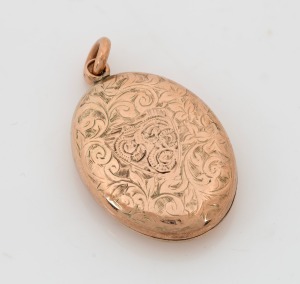 An antique 9ct gold locket with engraved decoration, circa 1900, ​​​​​​​3.3cm high overall, 8.9 grams total including non gold elements.