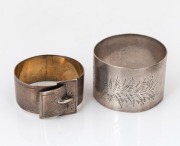 Two antique Australian silver napkin rings, one with belt decoration and faux English marks (most likely Adelaide origin), the other with engraved fern decoration, 19th century, ​​​​​​​57 grams total.