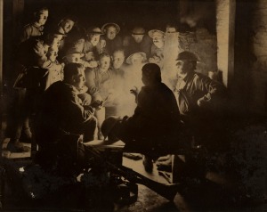 FRANK HURLEY Infantrymen Of The 1st Division During A Rest In The Dugouts At Ypres, 1917, large format antique sepia toned albumen print laid down on card (with numerous losses to mount and edge of sheet), sheet size 32 x 40cm, 43.5 x 54cm overall