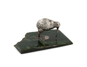 An antique New Zealand silver plated kiwi bird ornament mounted on a greenstone base, 19th/20th century, stamped "P.N.W.", 4.5cm high, 10cm wide.