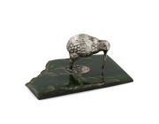 An antique New Zealand silver plated kiwi bird ornament mounted on a greenstone base, 19th/20th century, stamped "P.N.W.", ​​​​​​​4.5cm high, 10cm wide.