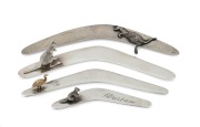 Four Australian silver boomerang letter openers, three with applied kangaroo decoration, the other with 9ct gold emu decoration, 20th century, the largest 14.5cm long, 89 grams total (including gold).
