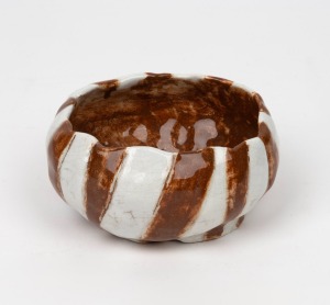 THEODORA COWAN hand-built pottery bowl, glazed in brown and cream stripes, incised gum leaf mark to base "Koala Pottery, T. Cohen, 1934", 6.5cm high, 13cm wide.