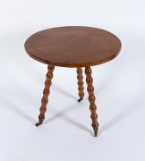 An Australian folk art circular cricket table with bobbin turned legs and brass casters, crafted in solid Tasmanian huon pine, 19th/20th century, 58cm high, 60cm diameter.