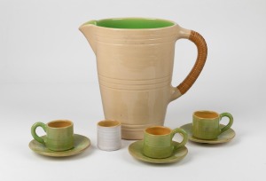 ALLAN LOWE pottery jug with rattan handle, together with three coffee cups, three saucers (one badly damaged), and a toothpick holder, (8 items), all incised "Allan Lowe", the jug 23cm high