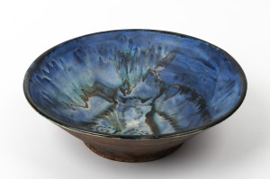 JOHN PERCEVAL blue glazed pottery fruit bowl with hand-painted bird decoration to the interior, signed "Perceval", 11cm high, 35cm diameter