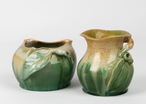 REMUED two green glazed pottery vases with applied gumnuts, leaves and branch handles, A/F, both incised "Remued", 10cm and 8cm high