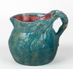 PEGGY WHITING turquoise and pink glazed pottery jug with applied windswept tree decoration and handle, incised "Peggy Whiting", ​​​​​​​13cm high.