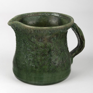 MERRIC BOYD green glazed pottery jug with applied gum leaf handle, incised "Boyd, 1921", ​​​​​​​11cm high.