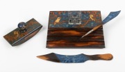 An unusual pokerwork folk art desk set with hand-painted kookaburra decoration on blue ground, circa 1920, (4 items), the paper knife 25.5cm long.