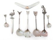 An antique Australian silver boomerang shaped letter opener with 9ct gold map of Australia, together with an Australian silver emu letter opener by PALFREY of Melbourne; plus six assorted Australian silver and shell spoons with Tasmanian maps of Aborigina