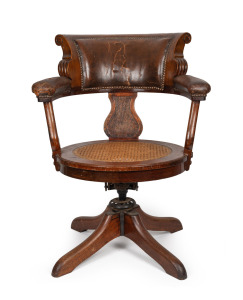 328a · An antique Australian Tasmanian blackwood captains chair with cane seat, leather upholstered back rest and arms and original adjustable swivel mechanism, circa 1890, formerly part of the furnishings of Parliament House, Hobart, Tasmania, 90cm high, 70cm across the arms.