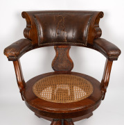 An antique Australian Tasmanian blackwood captains chair with cane seat, leather upholstered back rest and arms and original adjustable swivel mechanism, circa 1890, formerly part of the furnishings of Parliament House, Hobart, Tasmania, 90cm high, 70cm a - 2