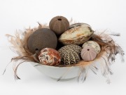 AUSTRALIANA: Ceramic bowl lined with emu feathers, housing a selection of natural history artefacts and ceramic ornaments including signed examples, the bowl 26cm diameter