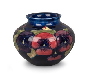 MOORCROFT "Pansy" pattern pottery vase on blue ground, impressed "Moorcroft, Made In England" with underglazed blue initials "W.M.", 13​​​​​cm high, 15cm wide.