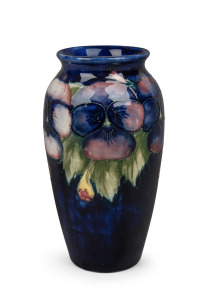 MOORCROFT "Pansy" pattern pottery vase on blue ground, impressed signature mark to base, 18.5cm high.