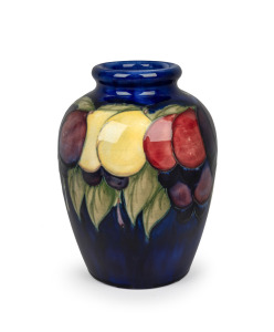 MOORCROFT "Wisteria" pattern pottery vase on blue ground, impressed mark to base, 17.5cm high.