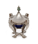 An English Arts & Crafts sterling silver lidded inkwell with greenstone finial and original Bristol blue glass liner, made in London, early 20th century, 11cm high overall, 195 grams (excluding glass liner).