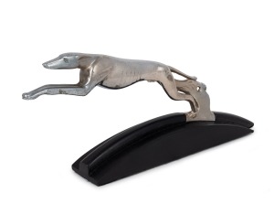 A vintage nickel plated greyhound car mascot mounted on ebonized timber base, 20cm high, 29cm long overall.