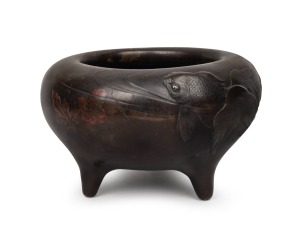 An antique Japanese bronze koro, attractively decorated with swimming koi carp design, Meiji period, 19th/20th century, 16cm high, 25cm diameter.