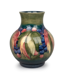 MOORCROFT "Leaves and Berries" pattern pottery vase on celadon and blue ground, impressed signature mark to base, ​​​​​​​24cm high.