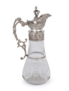 An antique cut crystal claret jug with ornate Continental silver mounts, 19th century, 35cm high.