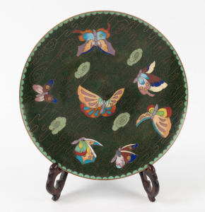 A Chinese cloisonne butterfly plate on rosewood stand, 20th century, 18.5cm diameter.