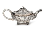 A Georgian sterling silver teapot adorned with floral finial and repousse decoration, made in London, circa 1823, ​​​​​​​12cm high, 30cm wide, 854 grams.