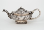 A Georgian sterling silver teapot adorned with floral finial and repousse decoration, made in London, circa 1823, ​​​​​​​12cm high, 30cm wide, 854 grams. - 2