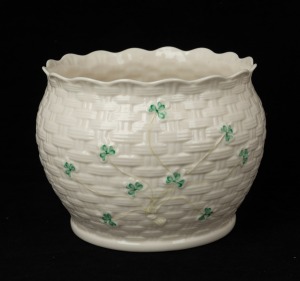 BELLEEK Irish porcelain basket weave jardiniere with shamrock decoration, brown factory mark to base, ​​​​​​​13.5cm high, 17cm wide.