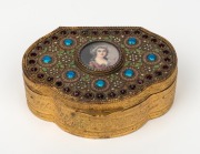 An antique Bohemian gilt metal trinket box, adorned with hand-painted miniature portrait of a lady on ivory, studded with rhinestones and finished in enamel, early 20th century, 10cm wide.