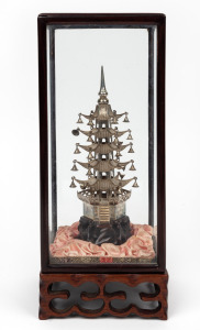 A Chinese silver pagoda ornament on carved timber stand in rosewood display case, 20th century, ​​​​​​​30cm high overall.
